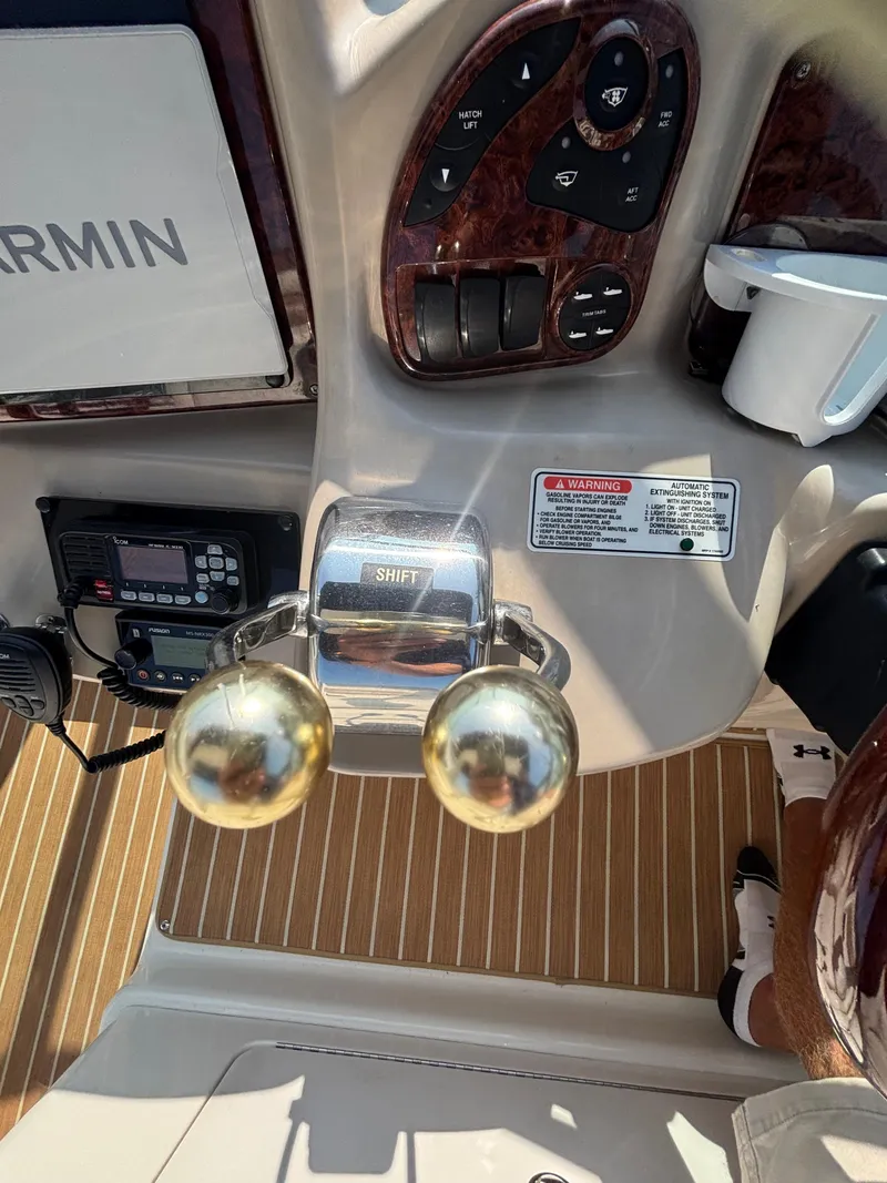 Slide: The Image of Control panel of a 2004 Sea Ray 320 Sundancer boat with Garmin equipment. - 32