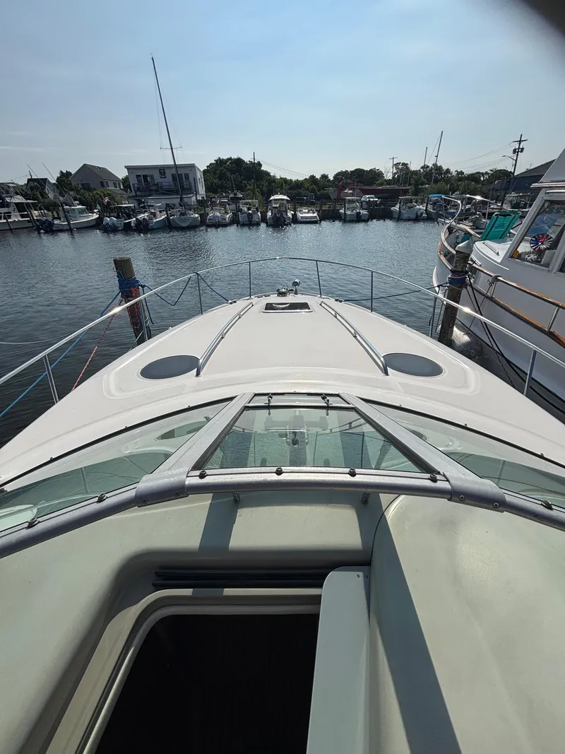 Slide: The Image of 2004 Sea Ray 320 Sundancer docked at marina, view from bow. - 33