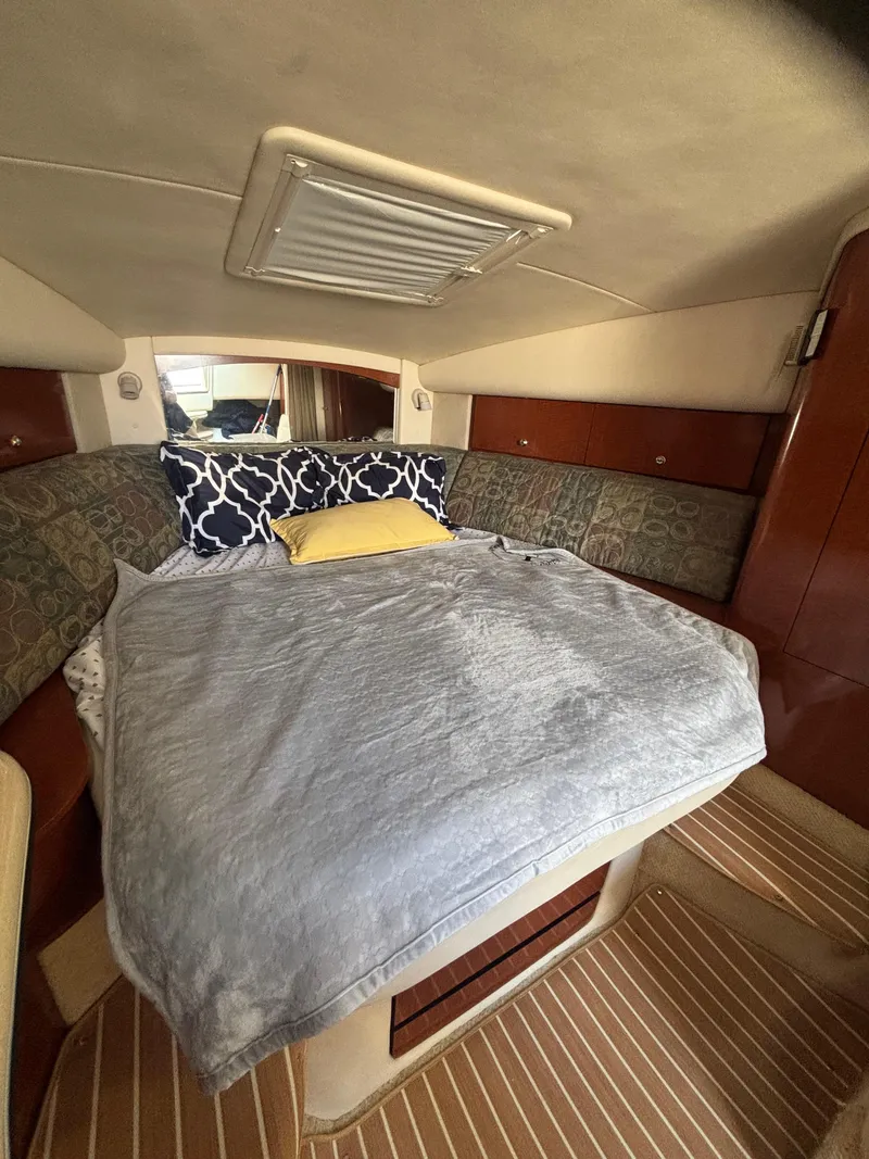 Slide: The Image of Cozy cabin interior of 2004 Sea Ray 320 Sundancer with bed and pillows. - 39