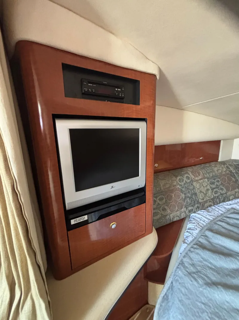Slide: The Image of 2004 Sea Ray 320 Sundancer cabin with built-in TV and DVD player. - 41