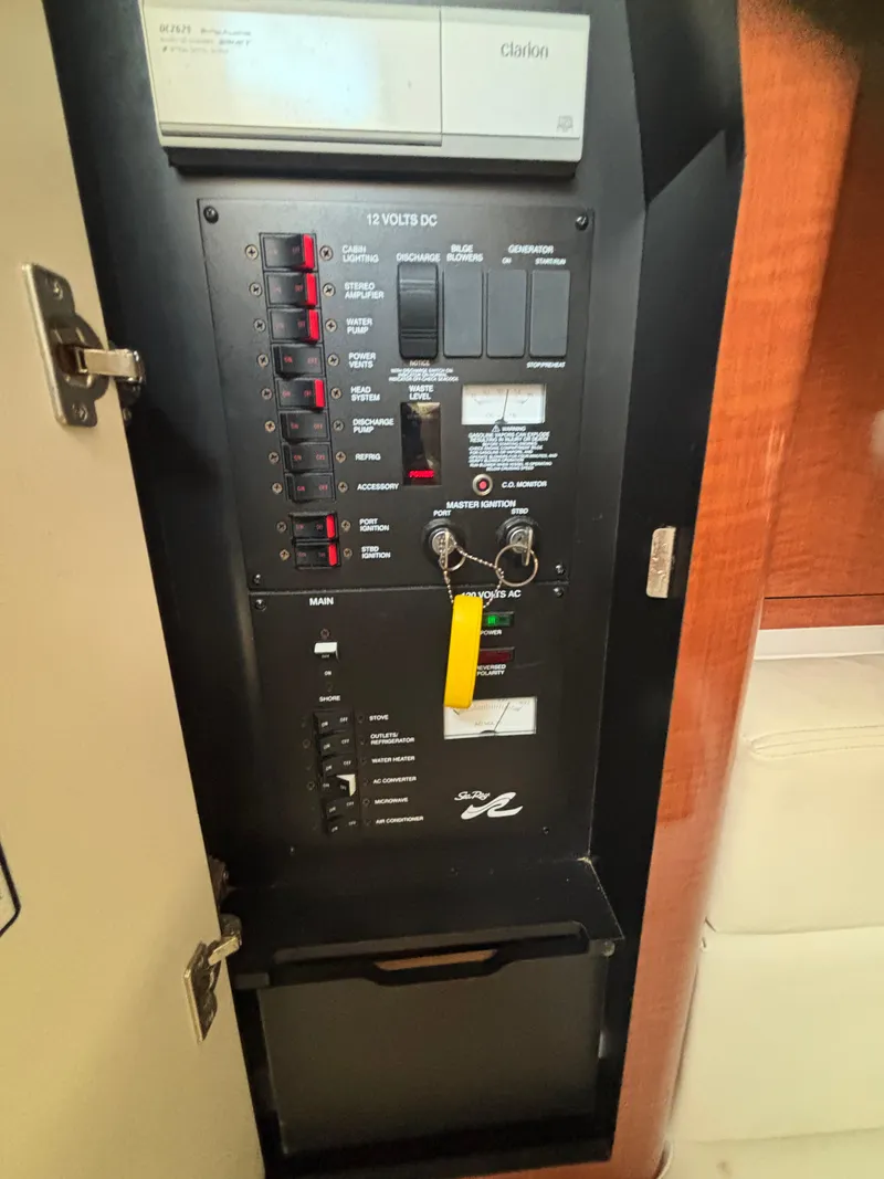 Slide: The Image of Electrical panel of 2004 Sea Ray 320 Sundancer boat, featuring switches and controls. - 44