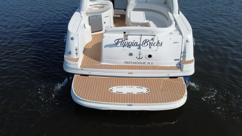 Slide: The Image of 2004 Sea Ray 320 Sundancer boat on water, rear view, wooden deck, Patchogue, NY. - 8