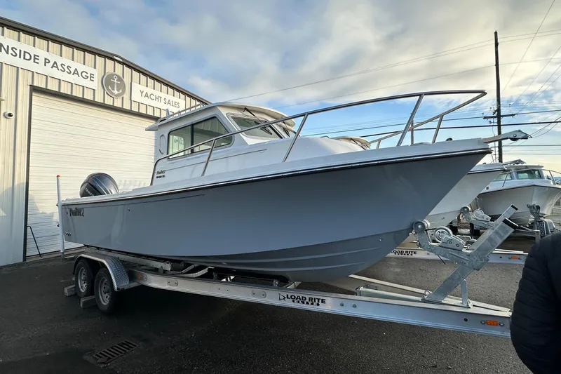 The Image of 2025 Parker 2420 Sport Cabin boat on trailer at yacht sales dealership. - 0