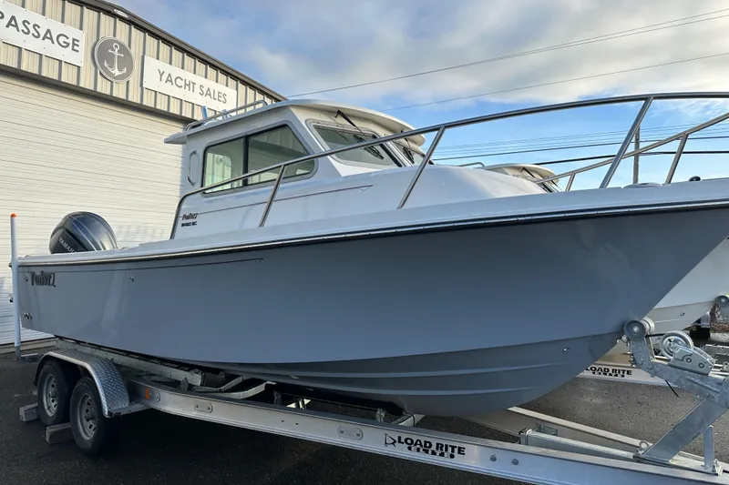 Slide: The Image of 2025 Parker 2420 Sport Cabin boat on trailer at yacht sales. - 2