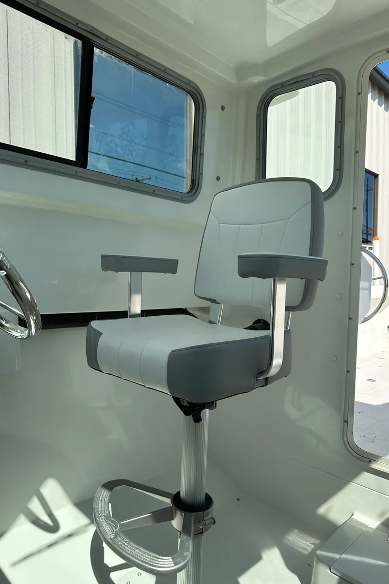 Slide: The Image of Captain's chair in 2025 Parker 2420 Sport Cabin boat interior. - 8