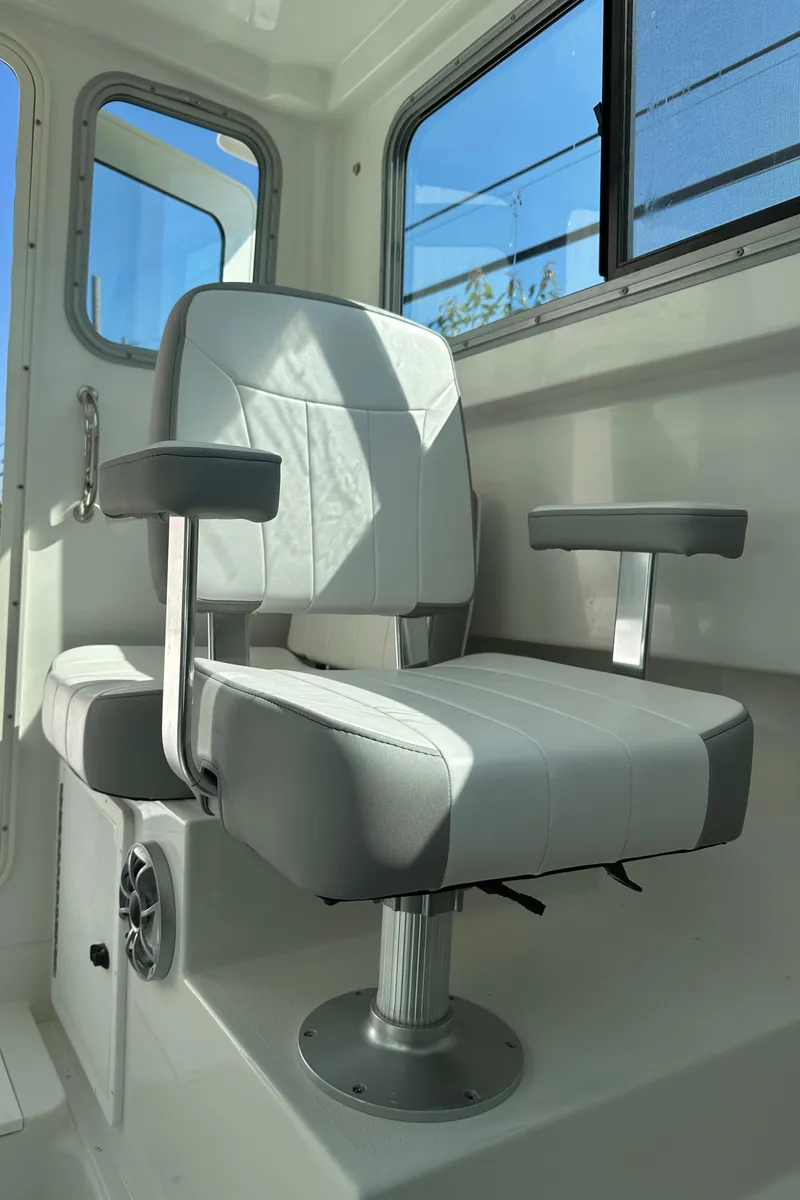 Slide: The Image of Captain's chair in 2025 Parker 2420 Sport Cabin boat interior. - 9