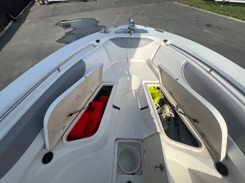 Slide: The Image of 2012 NauticStar 2500XS Offshore boat with open storage compartments on deck. - 20