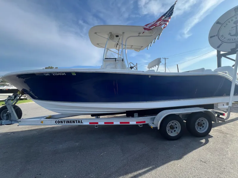 Slide: The Image of 2012 NauticStar 2500XS Offshore boat on trailer with American flag. - 9
