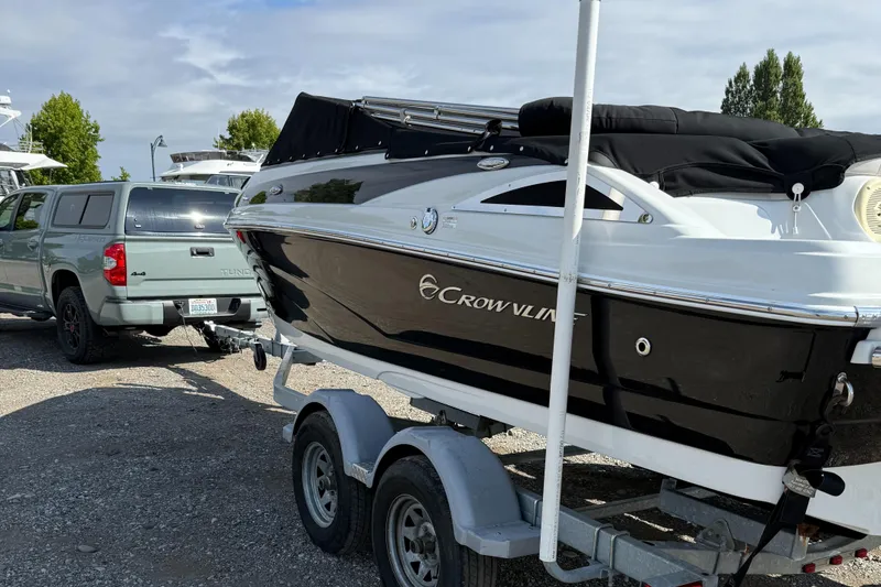 Slide: The Image of 2017 Crownline 205 SS boat on trailer, parked beside a pickup truck. - 15