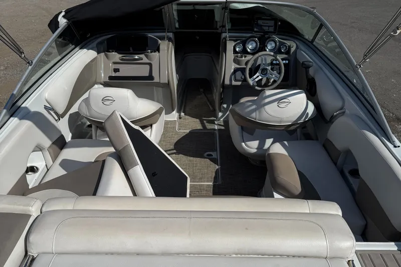 Slide: The Image of 2017 Crownline 205 SS boat interior with beige seating and modern dashboard. - 7