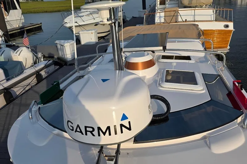Slide: The Image of 2023 Ranger Tugs R-27 boat with Garmin equipment docked at marina. - 2