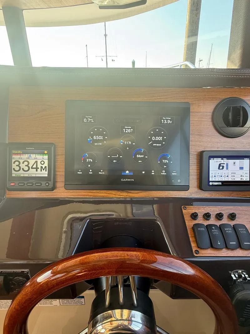 Slide: The Image of Dashboard of 2023 Ranger Tugs R-27 with Garmin navigation and control displays. - 7