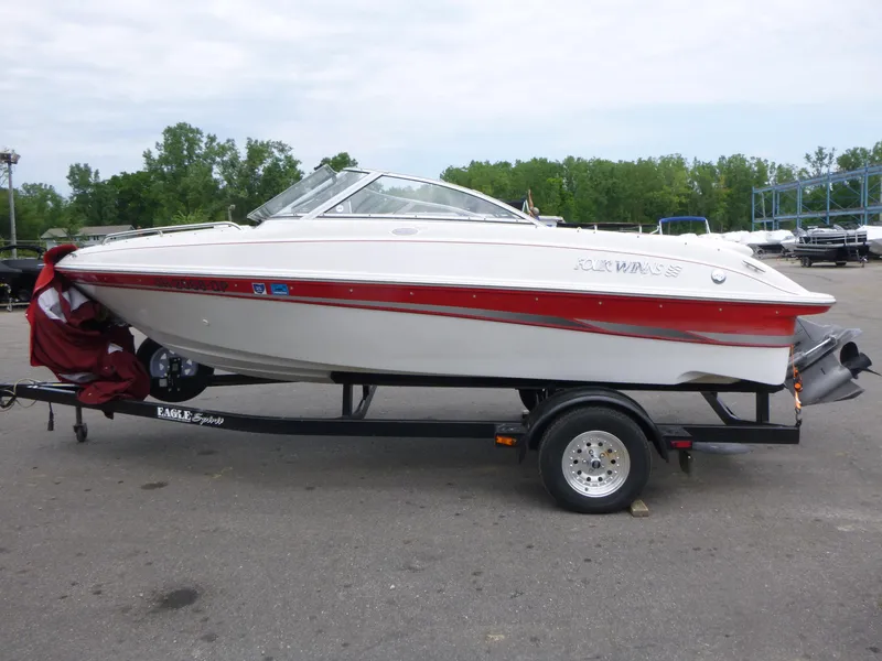 Slide: The Image of 2004 Four Winns 180 Horizon boat on trailer, white with red accents, parked outdoors. - 3