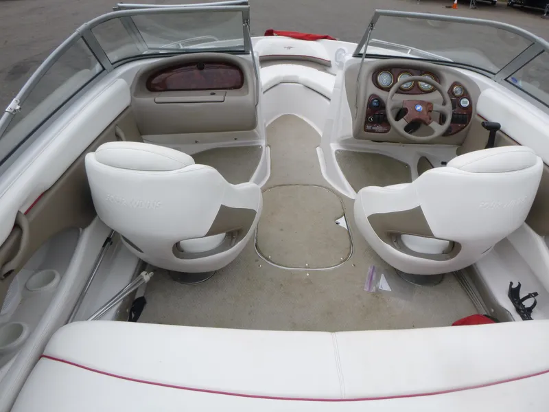 Slide: The Image of 2004 Four Winns 180 Horizon boat interior with white seating and dashboard. - 4