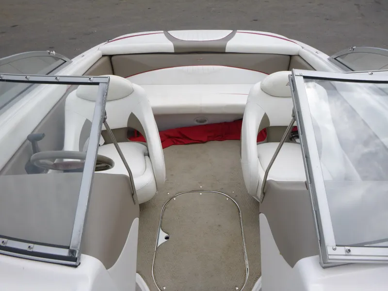 Slide: The Image of 2004 Four Winns 180 Horizon boat interior with white seating and windshield. - 5