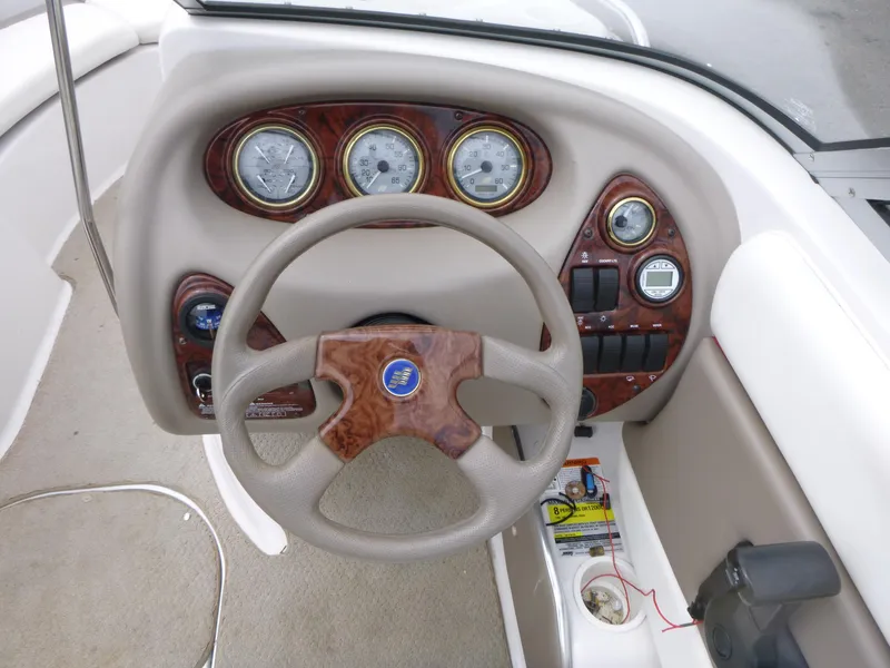 Slide: The Image of Dashboard of a 2004 Four Winns 180 Horizon boat with steering wheel and gauges. - 7