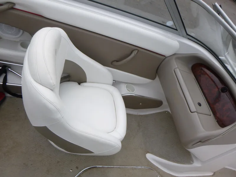 Slide: The Image of 2004 Four Winns 180 Horizon boat interior with white seating and dashboard. - 8