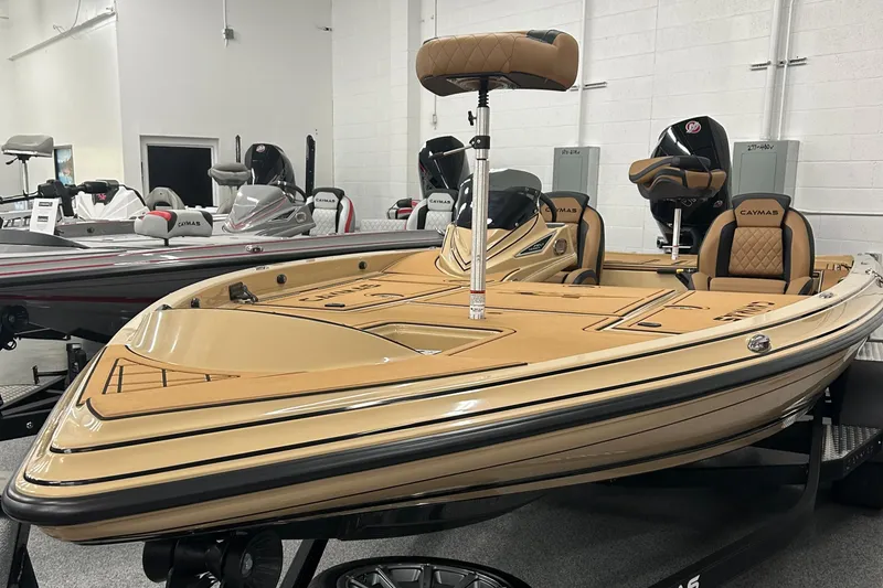The Image of 2025 Caymas XS 21 boat in showroom, featuring tan upholstery and sleek design. - 1