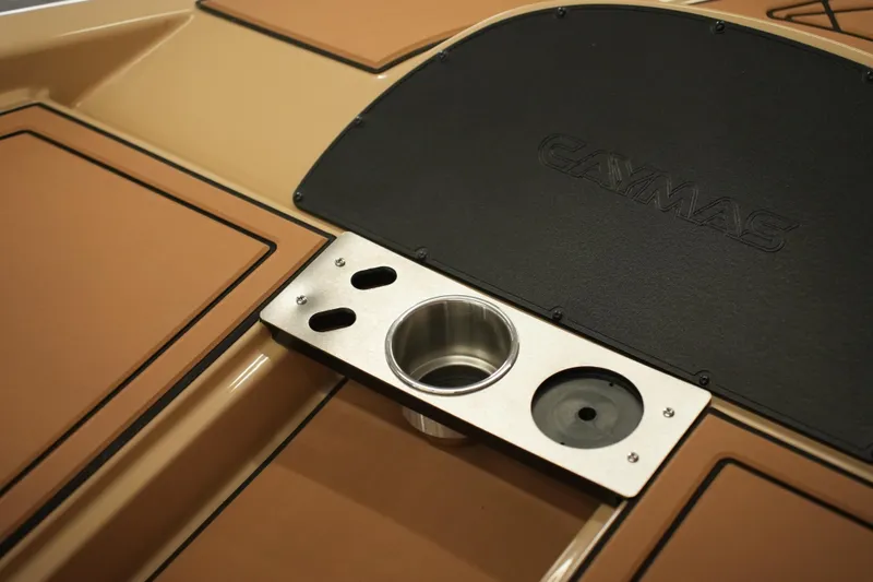 Slide: The Image of 2025 Caymas XS 20 PRO boat, beige exterior with chrome logo detail. - 10