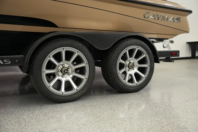 Slide: The Image of 2025 Caymas XS 20 PRO boat interior with tan quilted seats and modern steering console. - 18