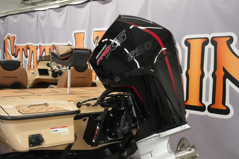 Slide: The Image of 2025 Caymas XS 20 PRO boat interior with tan and black quilted seats. - 19