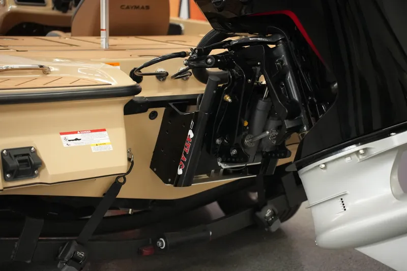 Slide: The Image of 2025 Caymas XS 20 PRO boat interior with open storage compartment and tan flooring. - 20