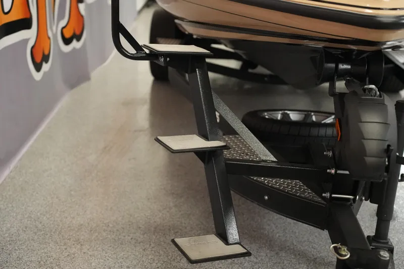 Slide: The Image of 2025 Caymas XS 20 PRO boat seat with tan and black design. - 23