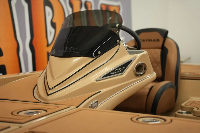 Slide: The Image of 2025 Caymas XS 20 PRO boat seat with logo in showroom setting. - 24