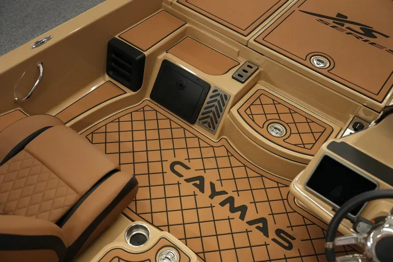 Slide: The Image of 2025 Caymas XS 20 PRO boat storage compartment with organized shelving and hydraulic lifts. - 25