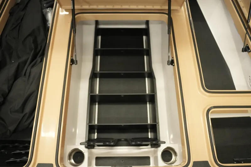 Slide: The Image of 2025 Caymas XS 20 PRO boat deck with storage compartments and branding. - 7