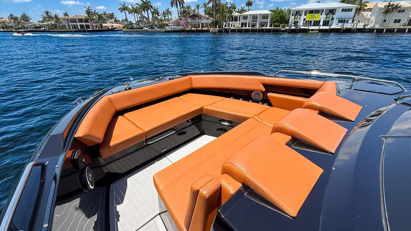 Slide: The Image of 2022 Cruisers Yachts 38 GLS with orange seating on a sunny waterfront. - 15