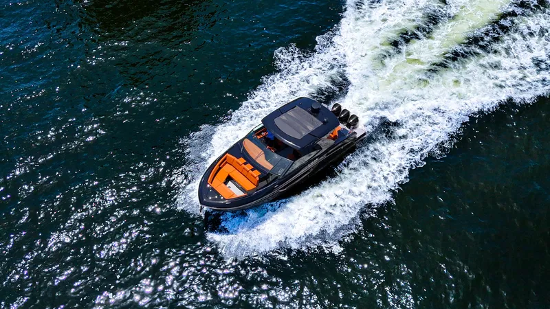 Slide: The Image of 2022 Cruisers Yachts 38 GLS speeding on open water, aerial view. - 2