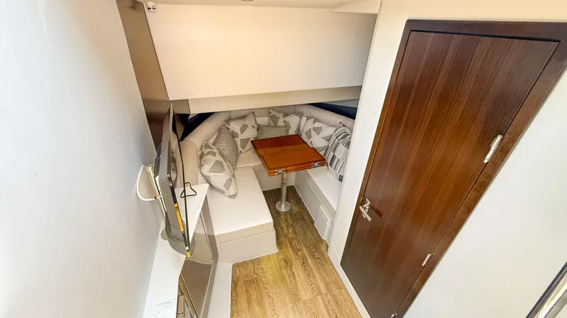 Slide: The Image of 2022 Cruisers Yachts 38 GLS interior with cozy seating and wooden table. - 17