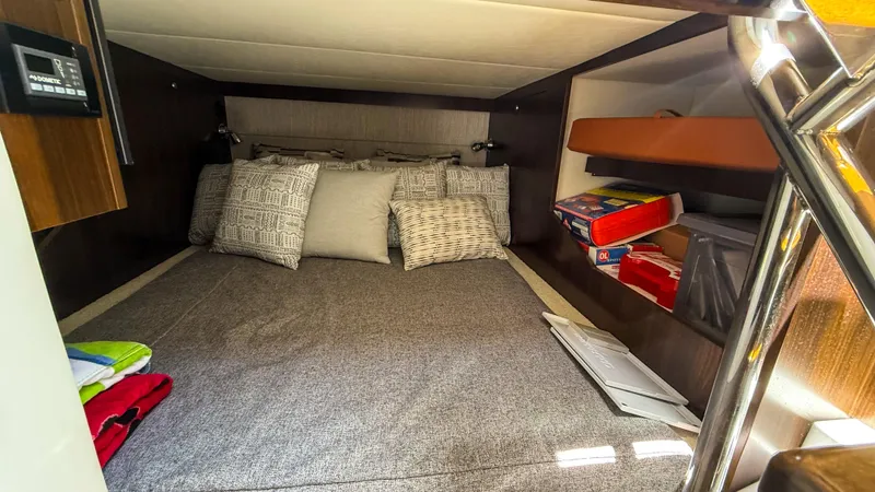 Slide: The Image of 2022 Cruisers Yachts 38 GLS cabin interior with bed and storage shelves. - 19