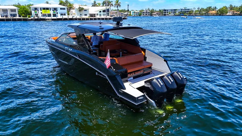 Slide: The Image of 2022 Cruisers Yachts 38 GLS luxury boat on water, featuring triple Mercury engines. - 3