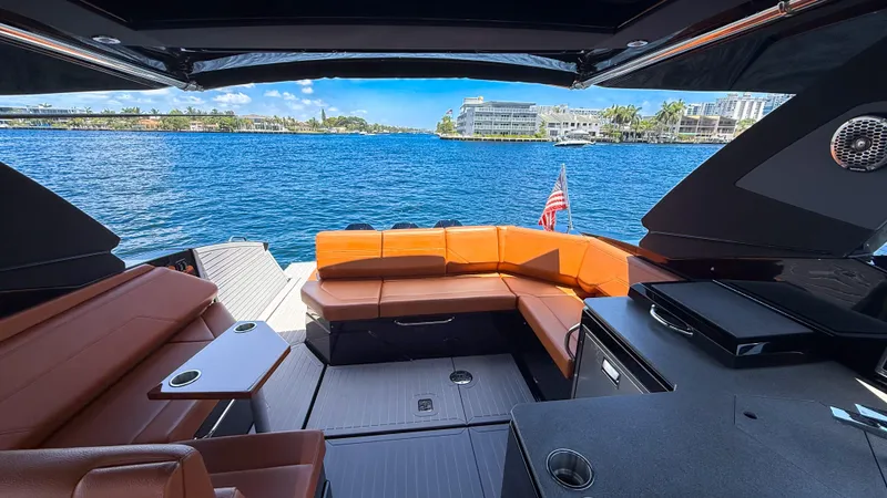 Slide: The Image of 2022 Cruisers Yachts 38 GLS interior with luxurious seating and scenic waterfront view. - 9