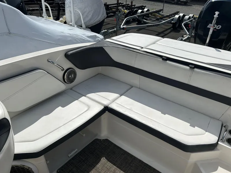 Slide: The Image of 2016 Sea Ray 21 SPX OB boat interior with white seating and speaker. - 10