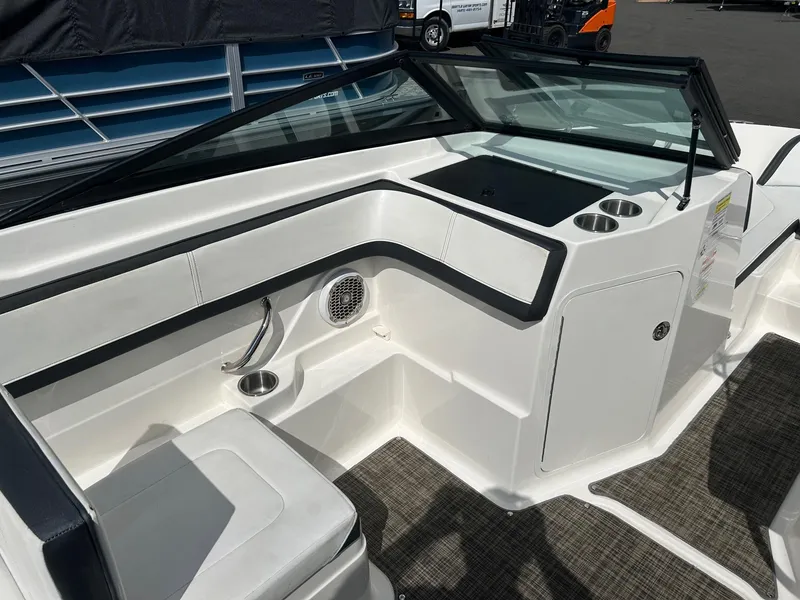 Slide: The Image of 2016 Sea Ray 21 SPX OB boat interior with seating and cup holders. - 11