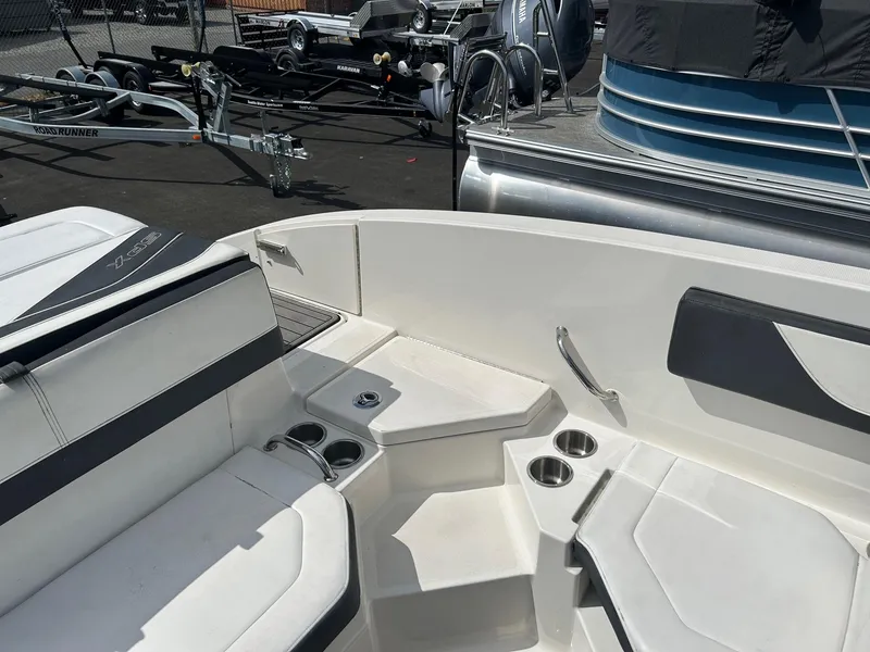 Slide: The Image of 2016 Sea Ray 21 SPX OB boat interior with seating and cup holders. - 12
