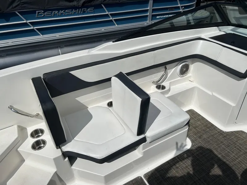 Slide: The Image of 2016 Sea Ray 21 SPX OB boat interior with white seating and cup holders. - 13