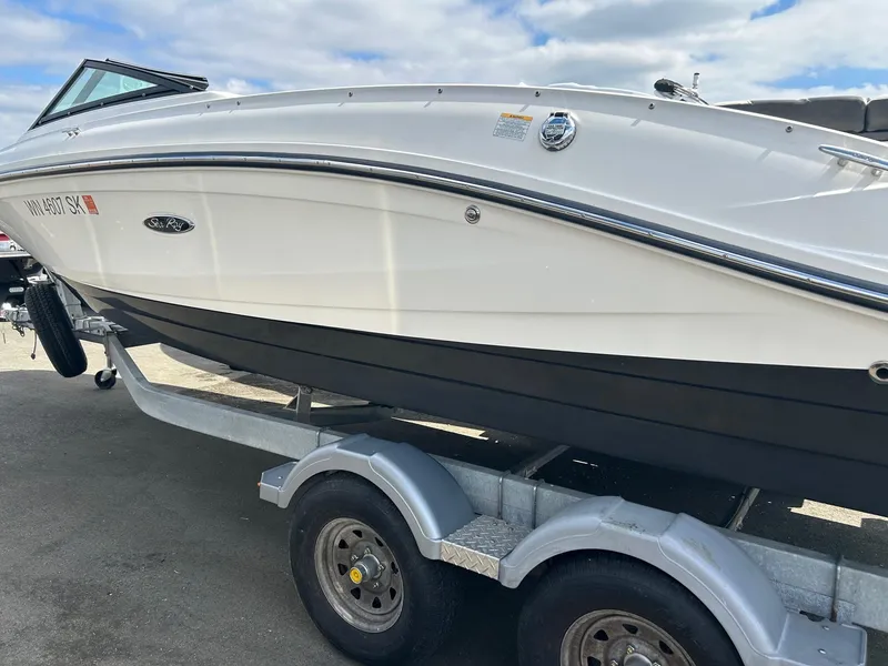 Slide: The Image of 2016 Sea Ray 21 SPX OB boat on trailer under a cloudy sky. - 16