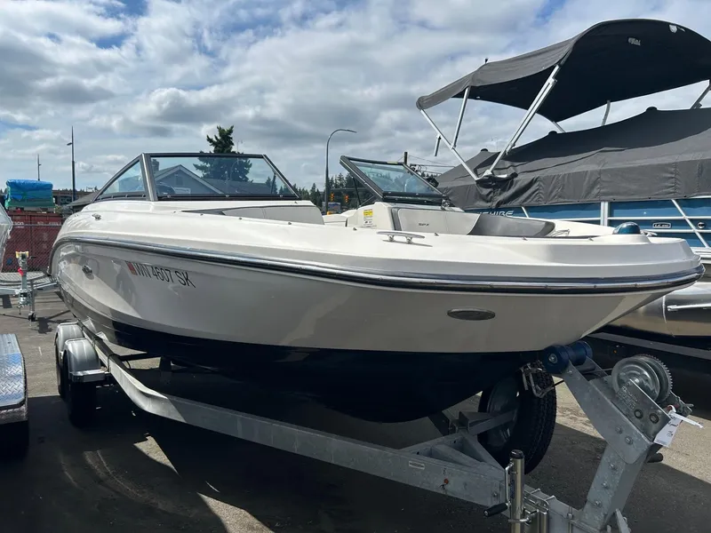 Slide: The Image of 2016 Sea Ray 21 SPX OB boat on trailer under cloudy sky. - 2
