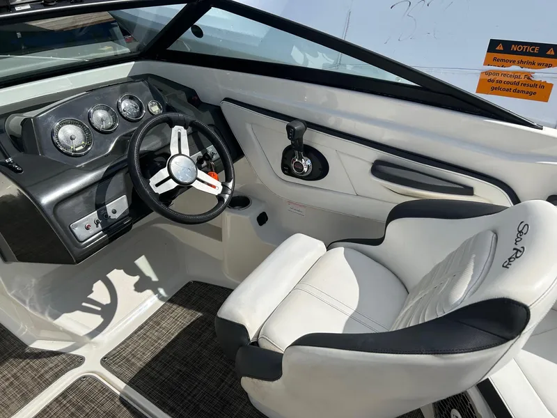 Slide: The Image of 2016 Sea Ray 21 SPX OB boat interior with steering wheel and gauges. - 8