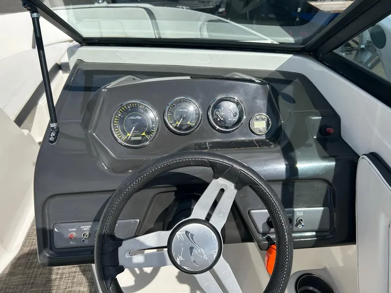 Slide: The Image of Dashboard of a 2016 Sea Ray 21 SPX OB boat with steering wheel and gauges. - 9
