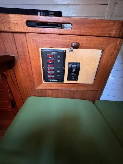 Slide: The Image of Electrical panel on a 1978 Baba 30 sailboat with wooden interior. - 11