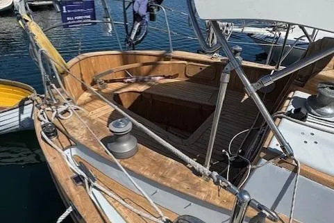 Slide: The Image of 1978 Baba 30 sailboat with wooden deck and rigging, docked at marina. - 3