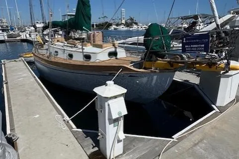 Slide: The Image of 1978 Baba 30 sailboat docked at marina, featuring classic design and wooden accents. - 34