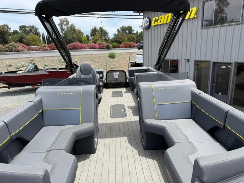 Slide: The Image of 2025 Manitou Explore pontoon boat with spacious seating and modern design. - 16