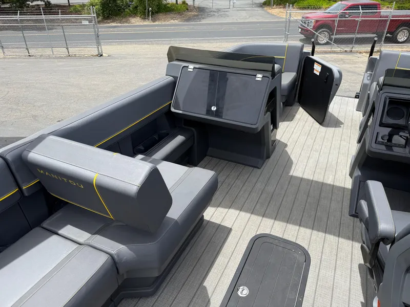 Slide: The Image of 2025 Manitou Explore boat interior with sleek seating and modern design. - 9