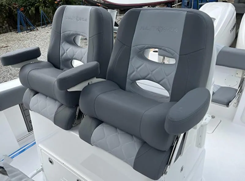 Slide: The Image of 2025 NauticStar 292 Legacy boat seats, featuring gray cushioned design with armrests. - 10